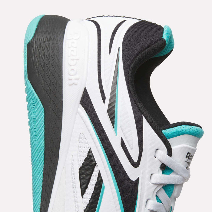 Side view of the Reebok Nano X5 Edge Training Shoes in white with black and teal details, showing the Reebok heel logo, textured midsole, black outsole, and teal lining—designed for peak performance workouts.