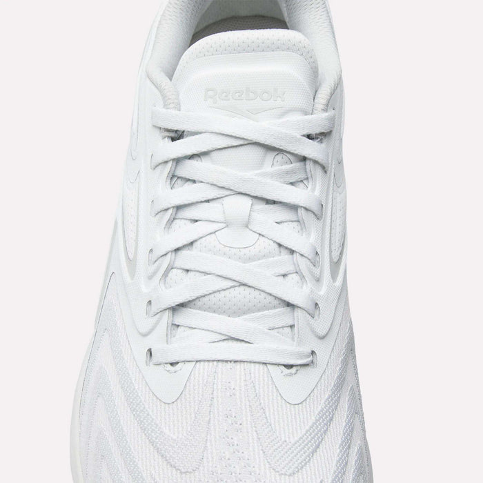 Top view of Reebok Nano X5 Edge Training Shoes in white with white laces, Flexweave textured upper, and embossed Reebok logo on the tongue—precision performance footwear for training.