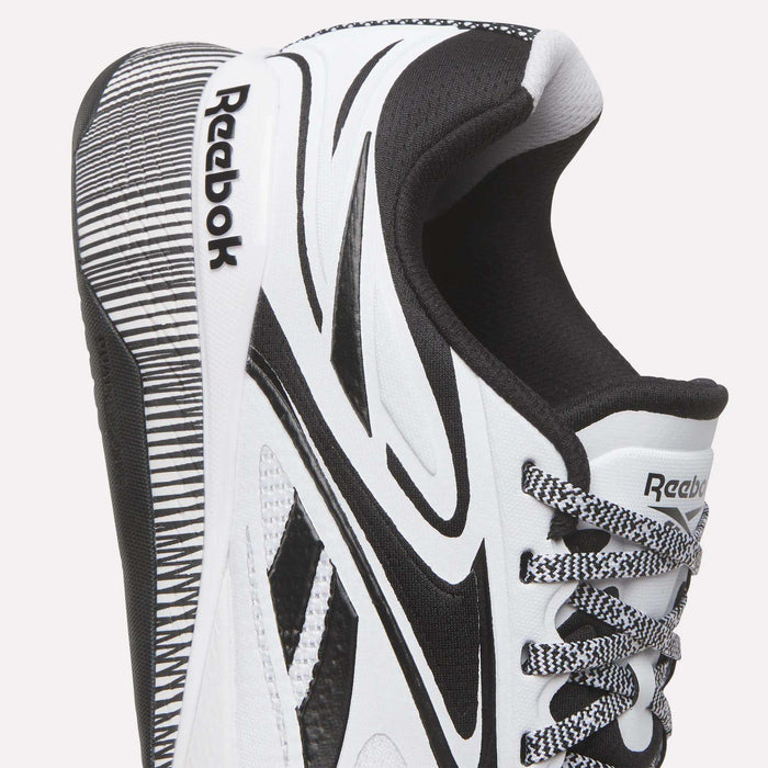 Close-up of the Reebok Nano X5 Edge Training Shoes in white and black, featuring the brand logo, stylish patterns, textured sole, and two-tone laces designed for top performance.