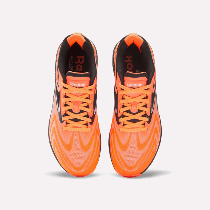 Top view of Reebok Nano X5 Edge Training Shoes in bright orange with black accents and orange laces, displayed side by side on a white background.
