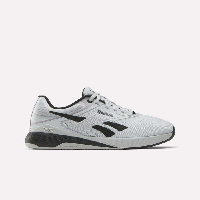 The Reebok Nano X5 Training Shoes feature a white design with black accents, black logo, grey sole, and mesh detailing, shown in side profile on a plain white background.