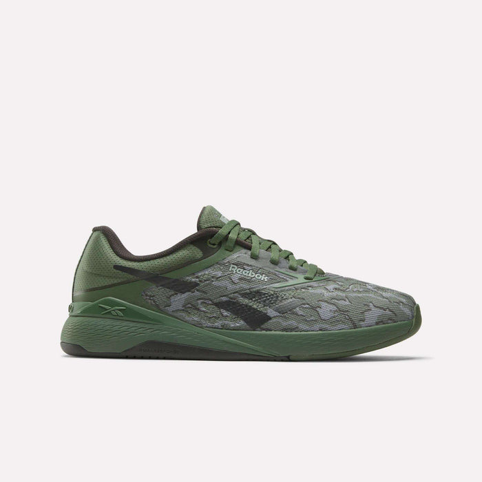 The Reebok Nano X5 Training Shoes, shown in side profile on a white background, feature a green camouflage pattern with black accents, combining iconic men's shoe style with the comfort and performance of athletic sneakers.