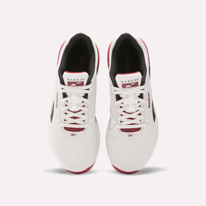 A pair of white Reebok Nano X5 training shoes with red and black accents, viewed from above, featuring laces, branded tongue, and mesh toe boxes against a light background. Perfect men’s workout shoes from Reebok.
