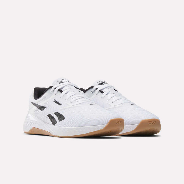 A pair of Reebok Nano X5 Training Shoes in white with black logo details, black and white accents, and light brown rubber soles, displayed on a plain white background.