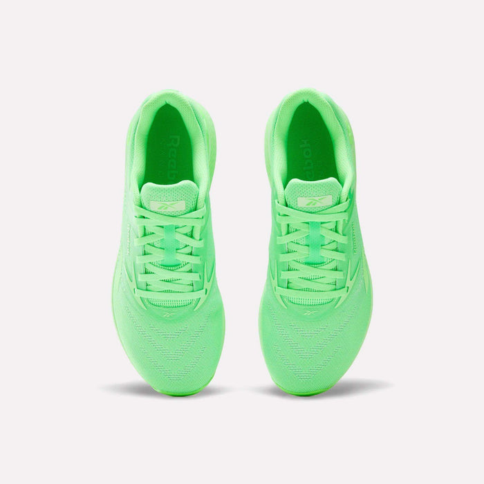 Top view of a pair of Reebok Nano X5 Training Shoes in neon green with laces, placed side by side on a white background for a comfortable and sporty look.