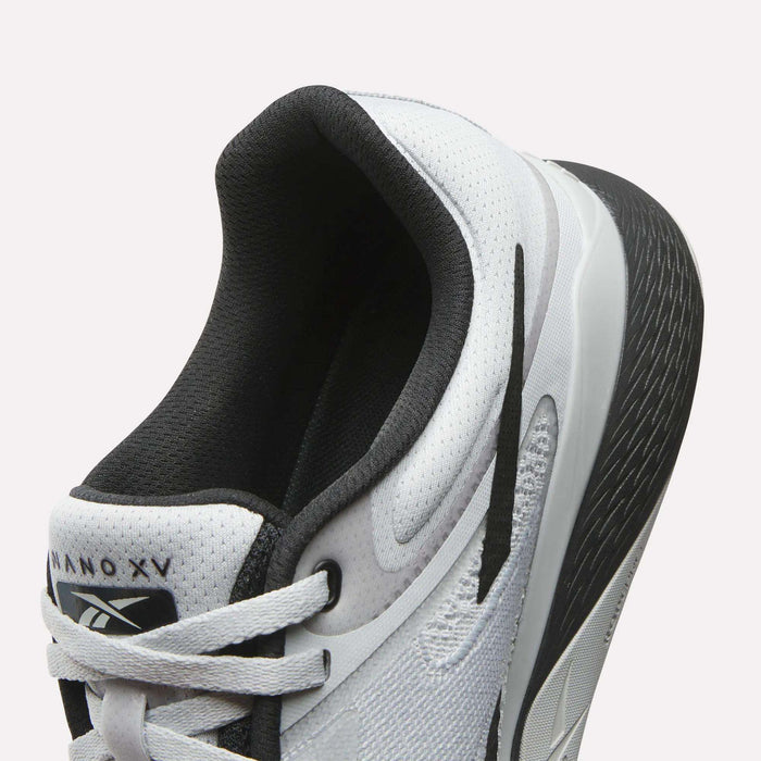 Close-up of a white Reebok Nano X5 Training Shoe with black and gray accents, textured sole, and “Nano X5” branding on the tongue. The breathable mesh upper makes it an ideal men’s training shoe.