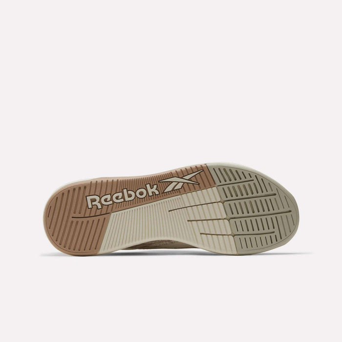 The sole of the Reebok Nano X5 Training Shoes for men, seen from below, displays textured grip patterns in tan and off-white along with a prominently featured Reebok logo.