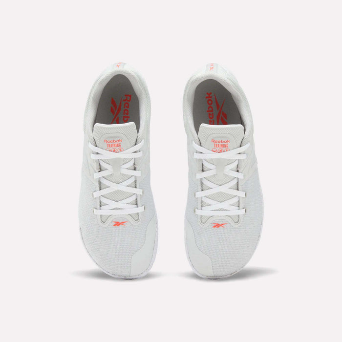 A pair of white Reebok Nano Zero Training Shoes, shown from above on a plain white background, feature red Reebok branding on the tongue and insole, white laces, a breathable mesh upper, and a zero-drop design.