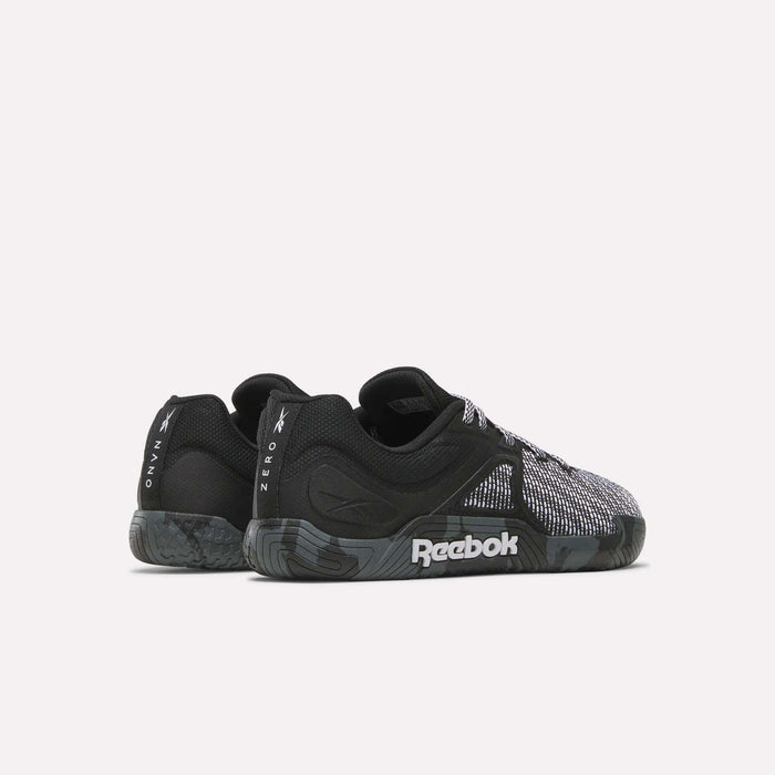 A pair of black and gray Reebok Nano Zero Training Shoes with textured soles and mesh details, ideal for strength training. Viewed from the side and slightly angled to the back. The Reebok logo is visible on the sole and heel.