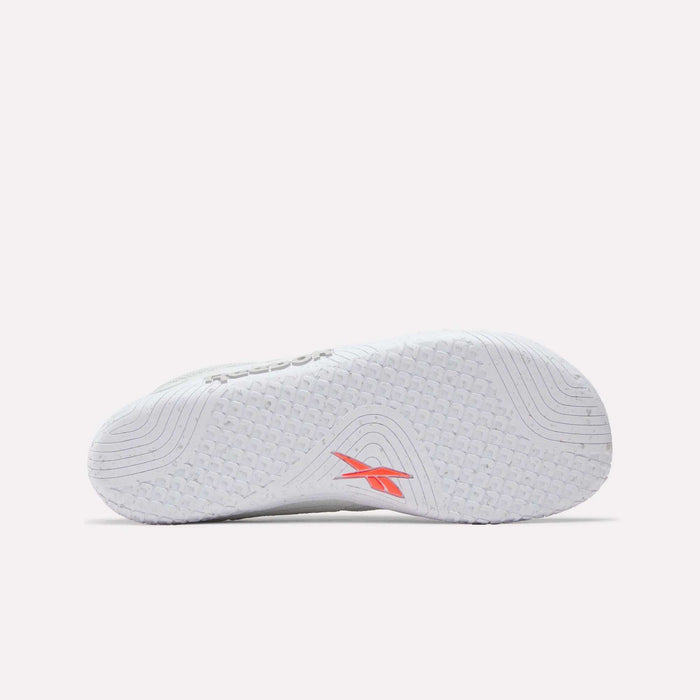 The image shows the white sole of Reebok Nano Zero Training Shoes, featuring textured grip patterns and a red Reebok logo near the arch. The background is plain and light.