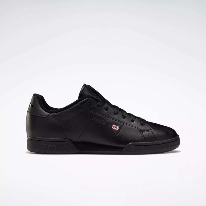 The Reebok Men's NPC II Shoes are displayed in black leather with a retro court style, black laces, and subtle branding in a side profile view—ideal for fans of men’s fashion sneakers.