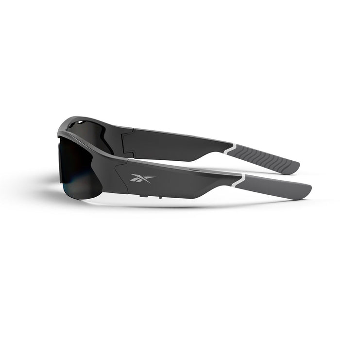 Reebok Octane Smart Audio Sunglasses in black and gray feature thick, angular frames, polarized lenses, and the Reebok logo on the side. Shown folded and resting on a white surface.
