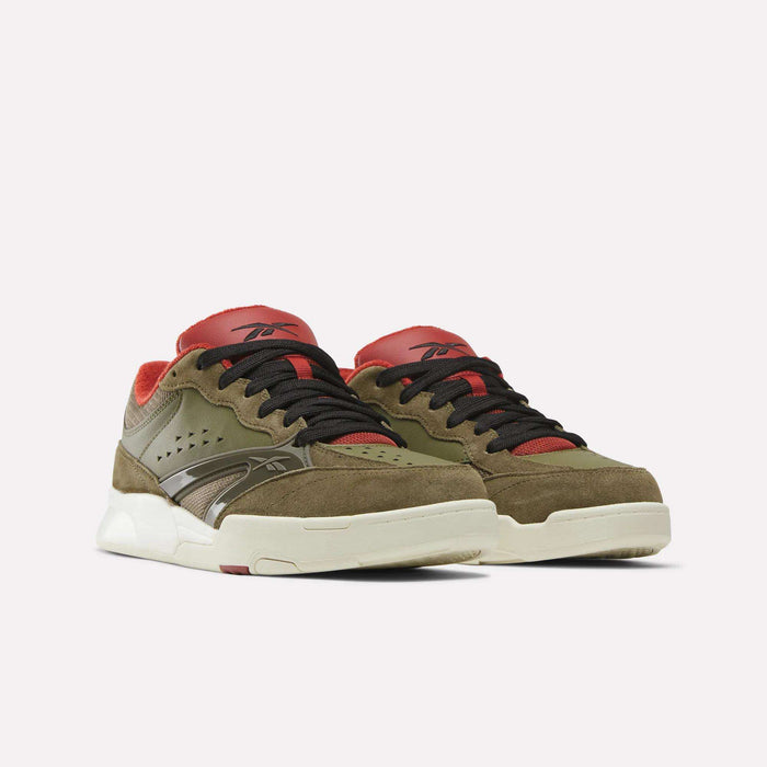 A pair of Reebok Omni Edge Shoes in olive green and brown, featuring black laces, red accents on the tongue and collar, and off-white soles, displayed against a plain white background.