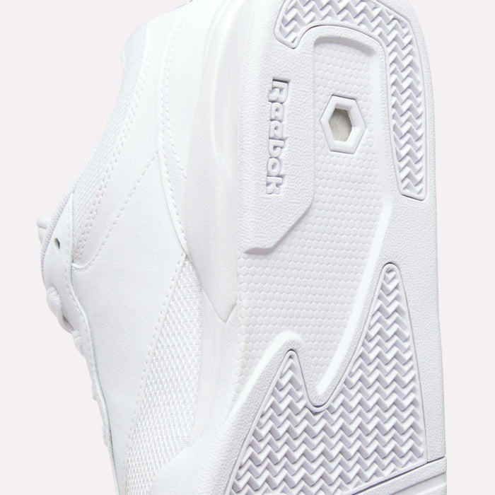 Close-up of the white sole and side of Reebok Omni Edge Shoes, highlighting textured patterns and the embossed Reebok logo near the sole. This retro basketball shoe by Reebok features a premium leather upper for enhanced style and durability.