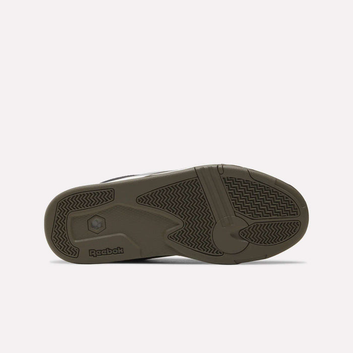 The image shows the bottom view of the Reebok Omni Edge Shoes, featuring their distinctive tread pattern and the Reebok logo on an olive-green rubber sole—a design inspired by premium materials commonly seen in hoops-style sneakers for confident grip both on and off the basketball court.