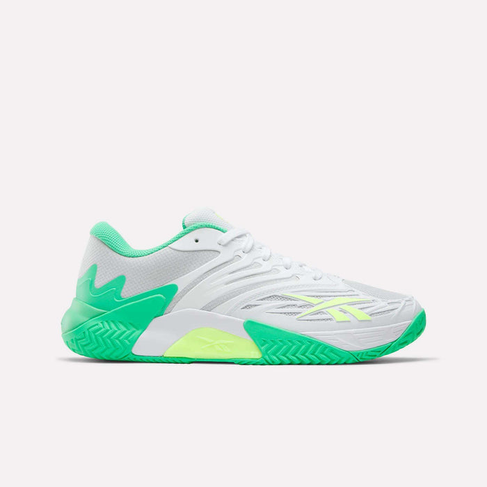The Reebok Phase EVO Tennis Shoes are white athletic sneakers with green accents, neon yellow details, and a textured green sole, shown in a side profile on a plain white background to highlight their tennis performance style.