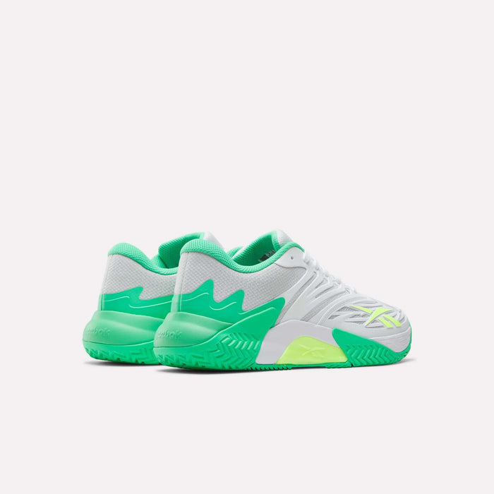 The Reebok Phase EVO Tennis Shoes are shown from a rear-side angle on a white background, featuring white mesh uppers with green and neon yellow accents, plus textured soles for breathability and performance.