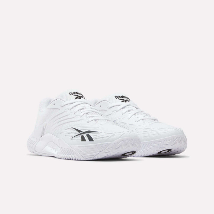 A pair of Reebok Phase EVO Tennis Shoes in white, featuring black Reebok logos on the sides and tongue, displayed on a plain light background.