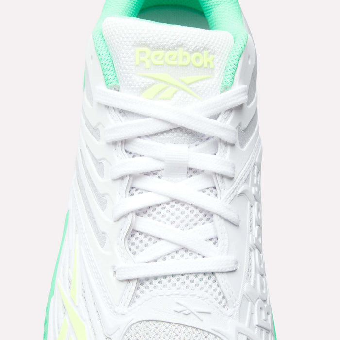 Top view of white Reebok Phase EVO Tennis Shoes accented in mint green and light yellow, featuring breathable mesh fabric, durable design, white laces, and the Reebok logo in light yellow on the tongue.