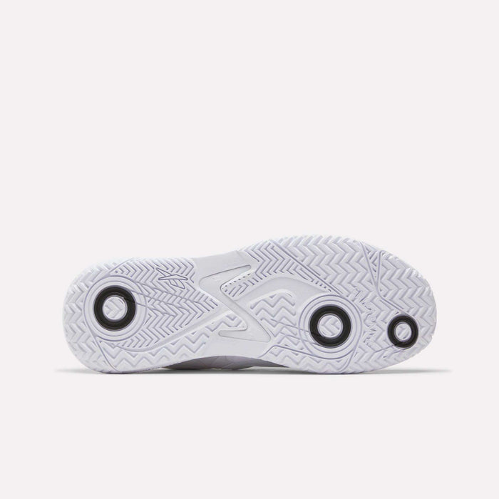 The image displays the white rubber outsole of the Reebok Phase EVO Tennis Shoes, featuring a durable herringbone tread pattern and three black circles, photographed on a plain white background.