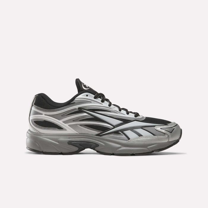 The Reebok Premier Road 1000 Shoes in Black/Silver/Grey4 are athletic sneakers inspired by Y2K designs, featuring black laces and a thick, cushioned sole, shown on a plain white background.
