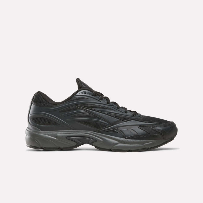 The Reebok Premier Road 1000 Shoes in Almostblack/Black are athletic sneakers inspired by retro running styles, featuring a chunky dark sole, a mesh upper, and sleek wavy design lines, shown in profile against a plain light background.