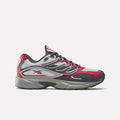 The Reebok Premier Road Control Shoes are shown in a side profile on a plain white background, featuring red, white, and gray colors with black accents, mesh panels, and the signature Reebok logo on the side.