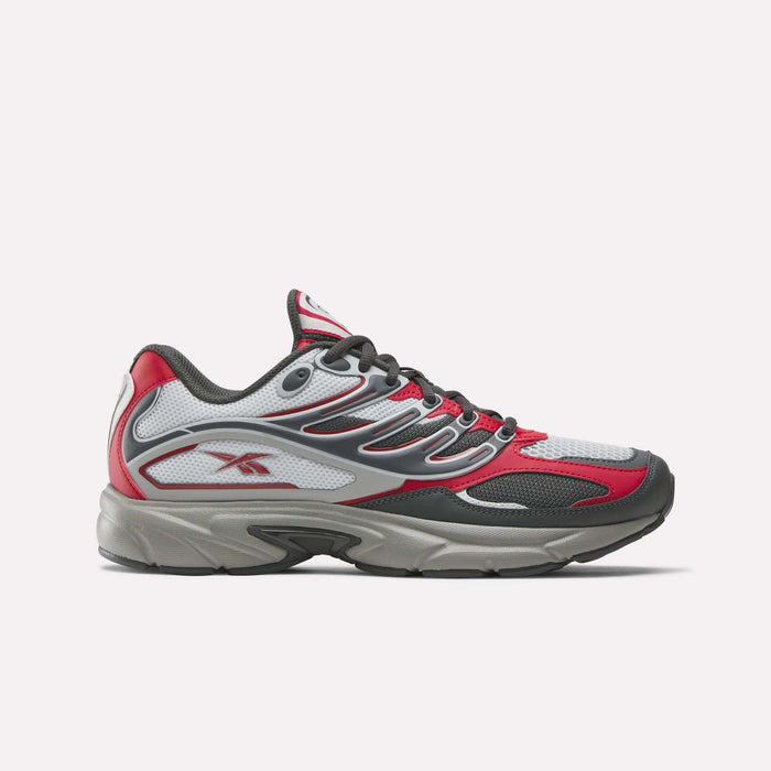The Reebok Premier Road Control Shoes are shown in a side profile on a plain white background, featuring red, white, and gray colors with black accents, mesh panels, and the signature Reebok logo on the side.