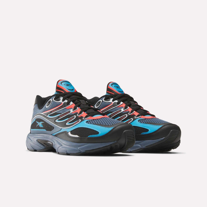 The Reebok Premier Road Control Shoes are retro running sneakers featuring a black base, blue mesh panels, red accents, gray outsoles, black laces, blue logo tongues, and modern sporty cushioning.