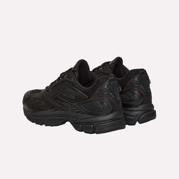 A pair of black Reebok Premier Road Ultra LTD Shoes, inspired by the archival running sneaker, showcase textured details and thick soles with a supportive dual-density midsole. They are positioned on a light background, angled away from the viewer.