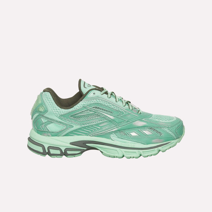 The Reebok Premier Road Ultra Shoes are mint green running sneakers with a mesh upper, textured overlays, dark green lining, and a chunky patterned sole with dual-density midsole, shown in side profile on a white background.