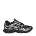 The Reebok Premier Road Ultra Shoes are displayed in a side profile against a white background, featuring a black and silver colorway with a mesh upper, intricate panel detailing, and a thick dual-density midsole for enhanced cushioning.