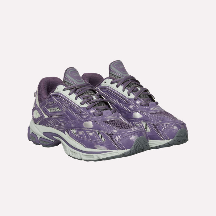 A pair of Reebok Premier Road Ultra Shoes in purple and gray, featuring mesh panels, chunky soles, and a dual-density midsole, are positioned side by side on a plain light background.