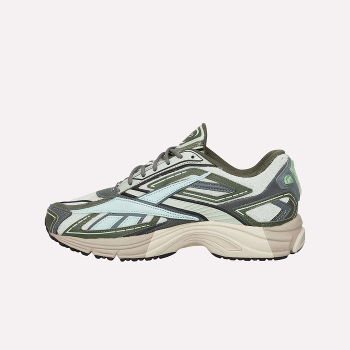 The Reebok Premier Road Ultra Shoes are a stylish archival running sneaker featuring a green, white, and black mesh upper, beige dual-density midsole, black outsole, and distinctive wavy design accents on the side.