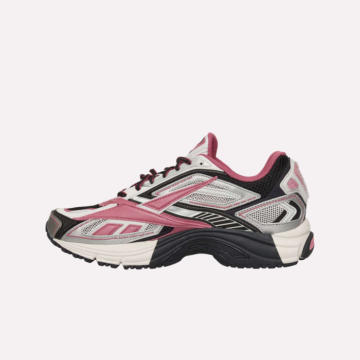 The Reebok Premier Road Ultra Shoes are shown in side profile against a plain light background, featuring a white, black, and pink color scheme with mesh panels, a dual-density midsole, black sole, and lace-up closure.