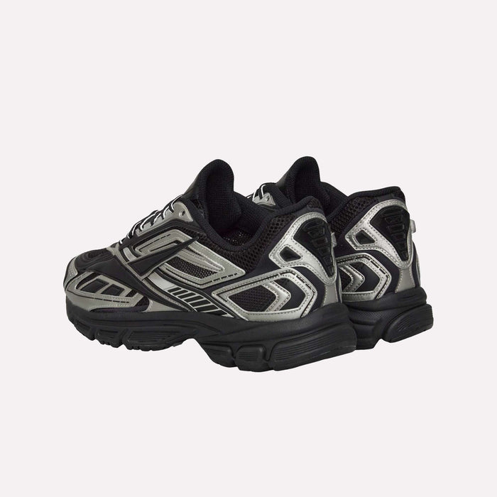 A pair of Reebok Premier Road Ultra Shoes in black and gray with silver accents, showcasing a dual-density midsole, are positioned with the heels facing the viewer against a plain white background.