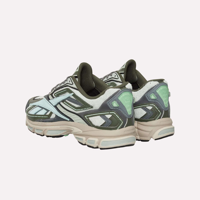 A pair of Reebok Premier Road Ultra Shoes—chunky, multicolored sneakers inspired by archival running styles and accented in green, white, gray, and mint—are angled from the back against a plain light background. Engineered with a dual-density midsole for enhanced comfort and stability, these shoes combine Reebok heritage design with modern performance features.