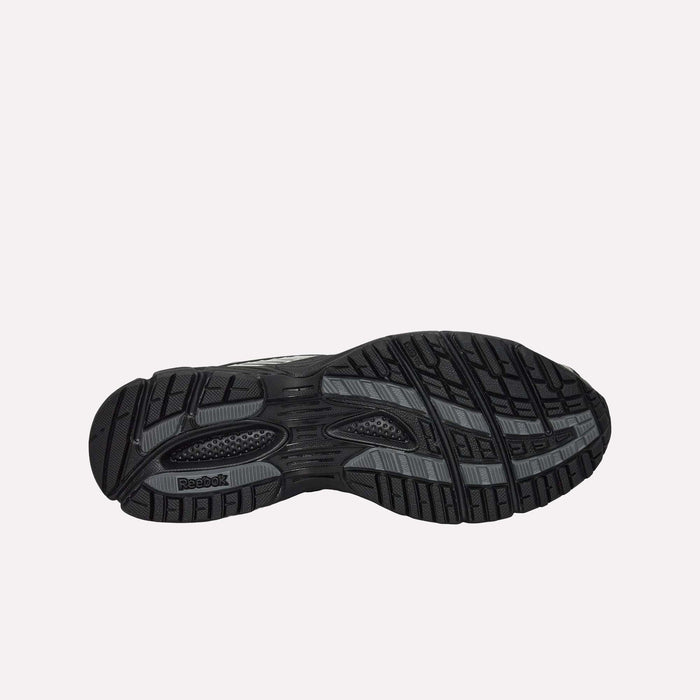 The black and gray rubber outsole of the Reebok Premier Road Ultra Shoes is shown from below, highlighting intricate tread patterns that offer superior grip and traction on a variety of surfaces. This detailed design works in tandem with the dual-density midsole to deliver enhanced comfort and performance.