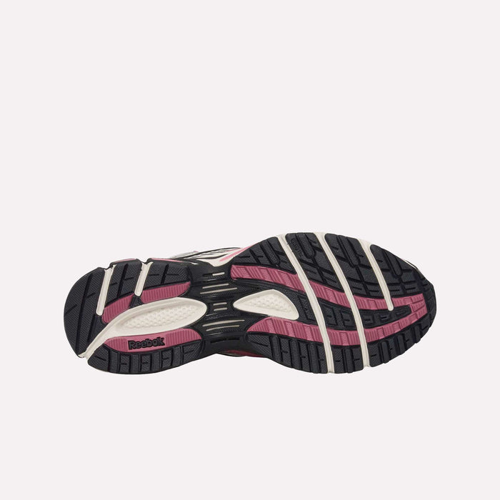 The image displays the sole of the Reebok Premier Road Ultra Shoes, featuring a black, pink, and white tread pattern as seen from the bottom against a plain light background. The design emphasizes the dual-density midsole from Reebok for improved comfort and support.
