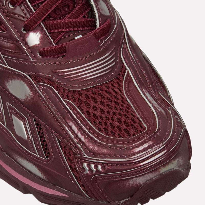 Close-up of the toe area of the Reebok Premier Road Ultra Shoes in maroon, inspired by an archival running silhouette and showcasing shiny and mesh textures, intricate stitching, and multiple design details.