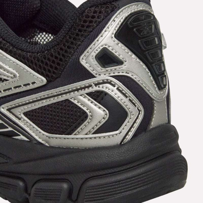 Close-up of the heel area of the Reebok Premier Road Ultra Shoes, a black and silver running sneaker featuring textured mesh fabric, metallic accents, detailed stitching, and a dual-density midsole designed for enhanced comfort.