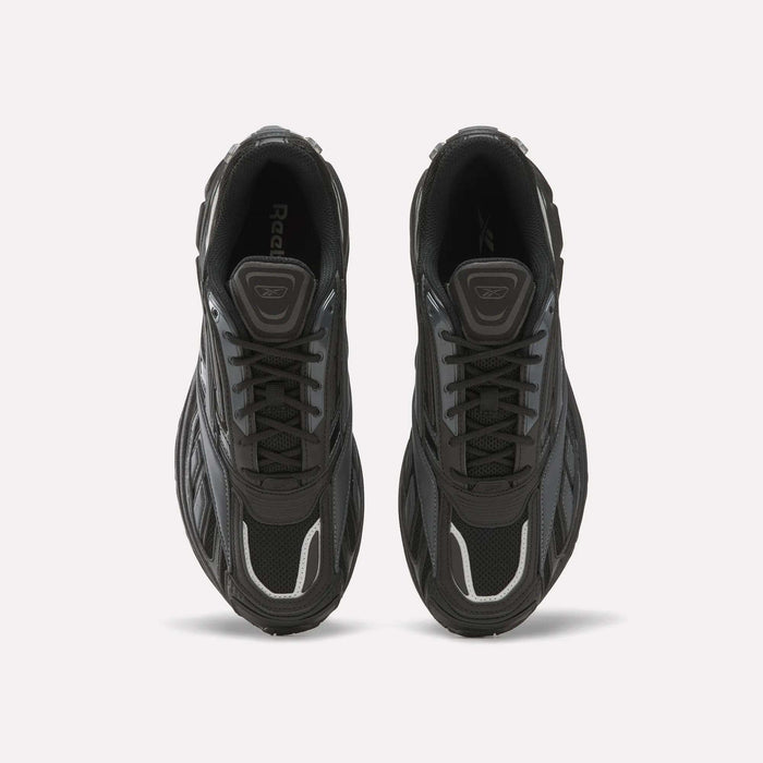Top view of a pair of black Reebok Premier Road Ultra SV athletic running sneakers with gray and white accents, laces tied, placed side by side on a plain white background. These shoes showcase classic style and comfort.