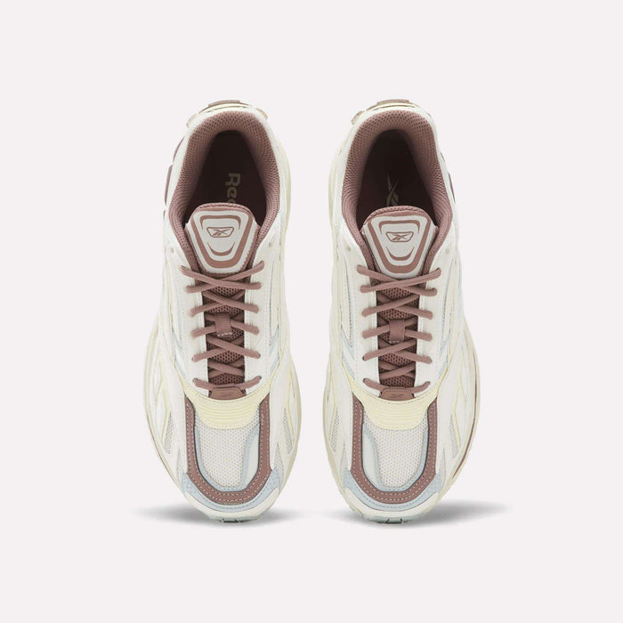 A top-down view of a pair of Reebok Premier Road Ultra SV Shoes in white and beige with brown laces, placed side by side on a plain white background.