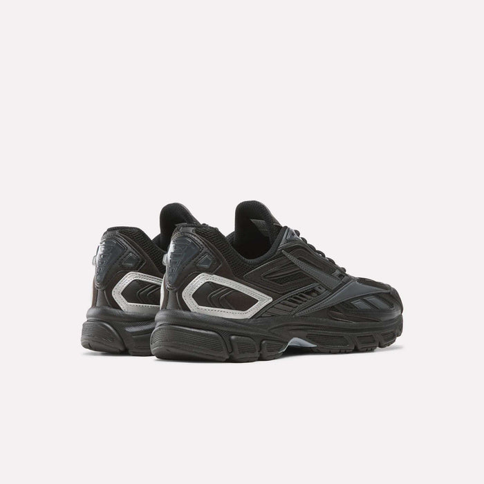 A pair of Reebok Premier Road Ultra SV Shoes in black with silver accents, displayed on a white background. The sneakers are angled to showcase both the sides and backs, featuring a design inspired by iconic Y2K running shoes.