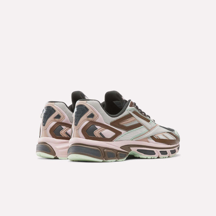 A pair of Reebok Premier Road Ultra SV Shoes are displayed from a rear angle on a plain light background, featuring pastel pink, mint green, brown, and gray tones that merge the retro charm of Y2K style with the comfort of modern running sneakers.