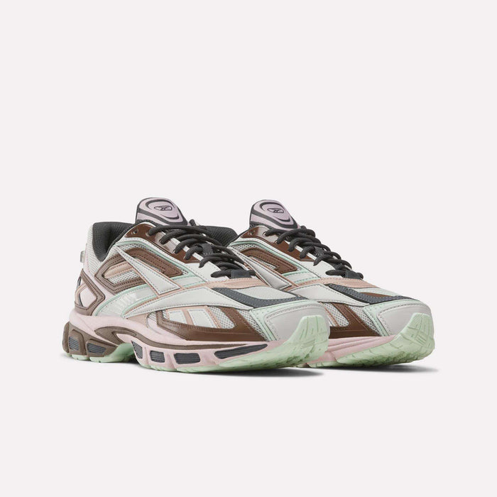 Introducing the Reebok Premier Road Ultra SV Shoes—a stylish pair inspired by Y2K designs, featuring pastel pink, brown, gray, and mint green accents. These sneakers showcase a chunky sole and layered panel construction reminiscent of classic Premier Road Ultra aesthetics, all presented on a clean white background.