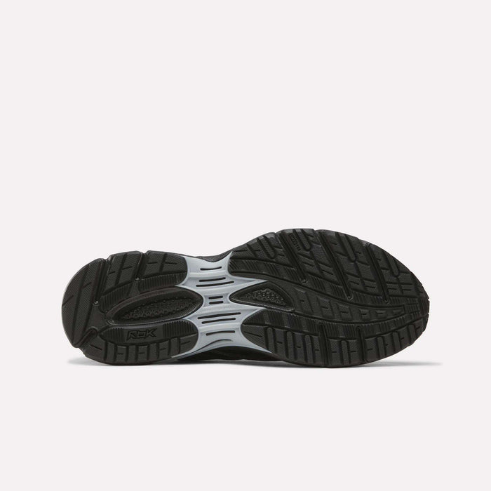 The image displays the black rubber outsole of a Reebok Premier Road Ultra SV Shoe, highlighted by a gray midsection and detailed with textured grooves and patterns for enhanced traction. The shoe is positioned sole up on a plain white background.