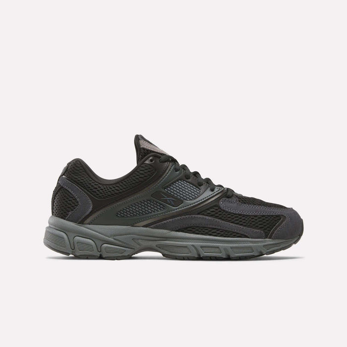 The Reebok Premier Trinity Shoes are black and dark gray athletic sneakers inspired by retro running, with mesh and synthetic overlays, a thick cushioned sole, and lace-up design, shown on a plain white background.