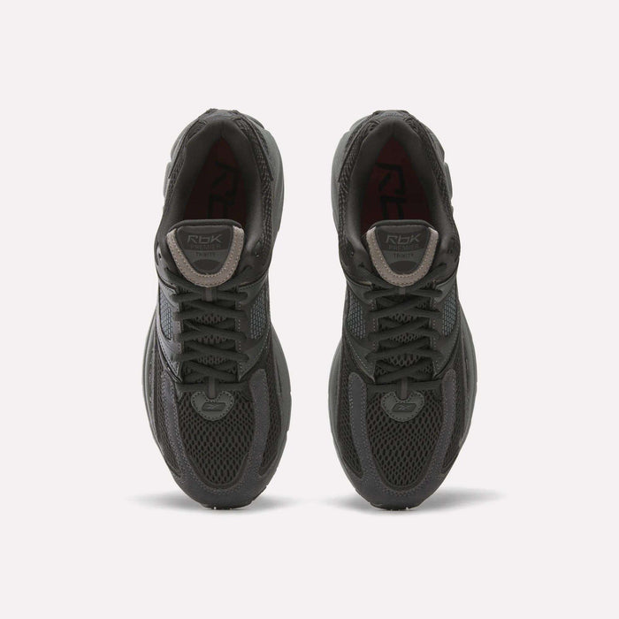 A pair of Reebok Premier Trinity women’s shoes in dark gray, viewed from above, with mesh uppers, laces, and logo patches on the tongues, side by side on a white background—ideal for running.