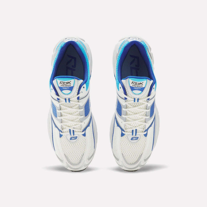 Top view of Reebok Premier Trinity Shoes—white mesh running shoes with blue accents and white laces—side by side on a plain white background, showcasing retro-inspired tech style.